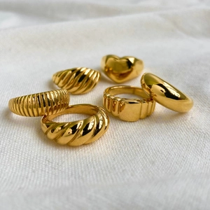 Six-piece set of elegant gold stainless steel rings with various textures and heart designs