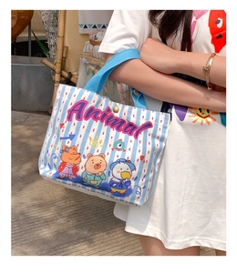 Detail of blue striped canvas tote with animal prints and sturdy blue handle strap
