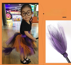 Detail of kids Halloween witch costume with purple mesh tutu skirt and matching broom