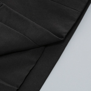 Macro d'un tissu noir de qualité montrant la texture détaillée de la robe blazer élégante