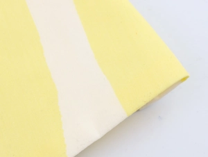 Macro detail of yellow and white striped canvas fabric with high-quality weave texture