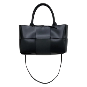 Fashionable black woven leather tote bag for women with dual handles and shoulder strap