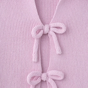Pink sweet knit cardigan featuring ribbed texture and front ribbon bow tie detail