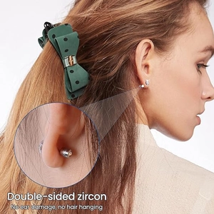 Close-up of double-sided zircon stud earrings with screw back design worn by a model