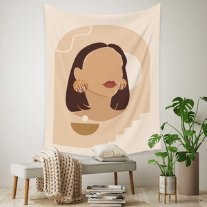 Detail of bohemian tapestry featuring a minimalist abstract woman portrait on a white wall