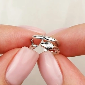 Detail shot of a silver double-layered open ring with a sparkling star-set zircon inlay