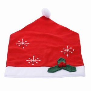 Christmas chair cover featuring red hat design with white snowflake embroidery and holly detail