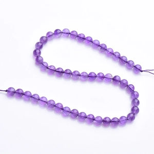 Uruguay natural amethyst round beads strand with transparent texture on white background