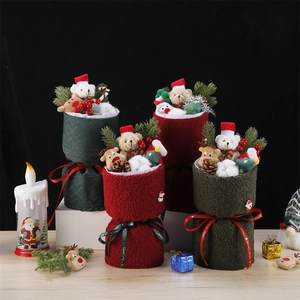 Detailed view of Christmas gift buckets with plush bears and festive pine cone decor
