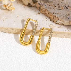 Close-up of gold plated U-shaped clip earrings with micro-paved sparkling cubic zirconia
