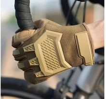 Close-up of khaki tactical half-finger gloves on handlebars for cycling and grip