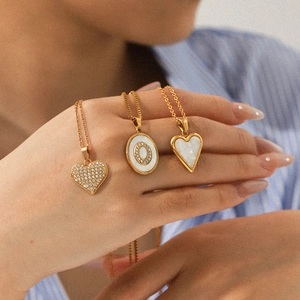 Three-layer gold necklaces with heart and oval crystal pendants and white shell inlay