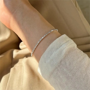 Close-up of S925 sterling silver crushed silver bracelet worn on a female wrist