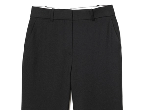 Detailed view of black tailored trousers with belt loops and side pockets texture