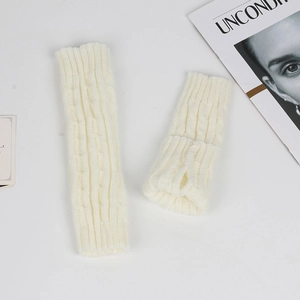 Close-up of white cable knit arm warmers showing soft textured knit pattern details