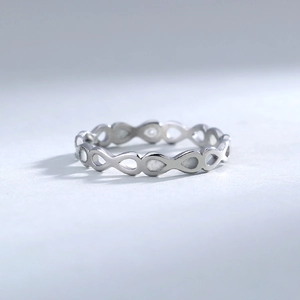 Macro shot of silver 304 stainless steel infinity heart ring with cutout design details