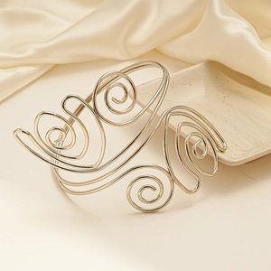 Artistic gold twisted metal arm cuff bracelet with elegant spiral floral design