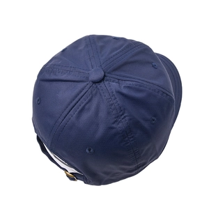 Top view of navy blue short brim baseball cap with metal buckle and ventilation eyelets