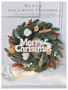 Detailed Christmas wreath featuring PE pine needles, cotton, cinnamon, and red berries