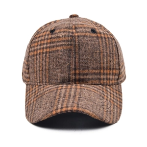 Close-up of wool plaid baseball cap showing premium brown checked fabric and stitching