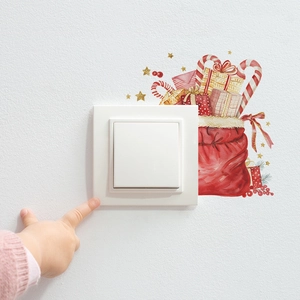 Détail d'autocollant de Noël pour interrupteur avec sac cadeau rouge et sucres d'orge