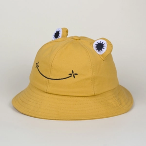 Detailed view of yellow frog bucket hat with 3D eyes and cute embroidered smiley face