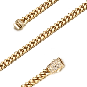 Close-up of golden Cuban link necklace featuring a luxury lobster clasp with small diamonds