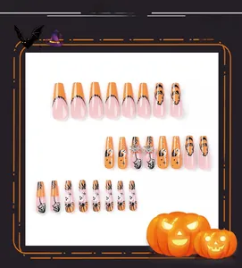 Detail of Halloween press-on nails featuring pumpkin, ghost, and rhinestone spider designs