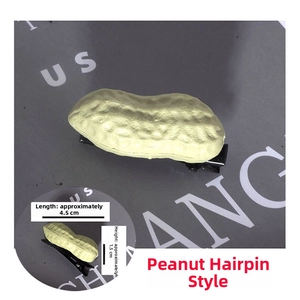 Detailed view of resin peanut hair clip featuring realistic texture and a black metal duckbill clip