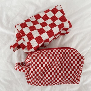 Red and white checkered seersucker makeup bag set with textured fabric and handles