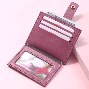 Detail of plum purple multi-slot card holder with ID window and metallic snap closure