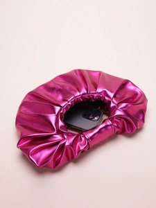 Detail showing inner capacity of metallic magenta pleated cloud bag with a smartphone inside