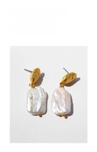 Macro detail of French vintage baroque pearl earrings with textured matte gold plating