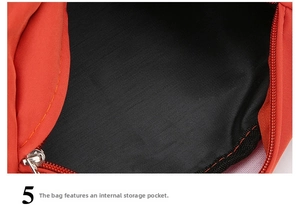 Detail showing the internal zippered storage pocket and black fabric lining of the red bag