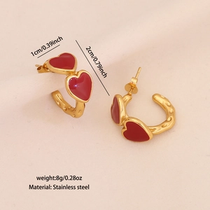 Detail view of red heart earrings showing 2cm diameter and 1cm width specifications