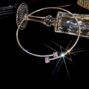 Close-up of silver choker necklace with pink gemstones and sparkling crystal details