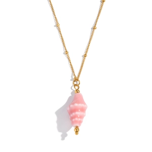 Detail of a pink conch shell pendant on a thin gold chain with pearl bead accents
