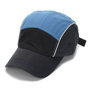 Close-up of a 5-panel color-block baseball cap featuring navy, sky blue, and black panels