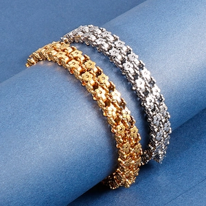 Gold and silver stainless steel flower chain bracelets wrapped on a blue cylinder