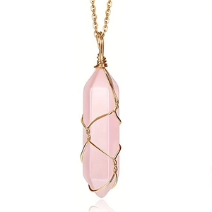 Detail of pink crystal hexagonal pendant with gold wire wrap and matching chain