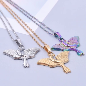 Three celestial moon and moth pendants in gold, silver, and rainbow finishes