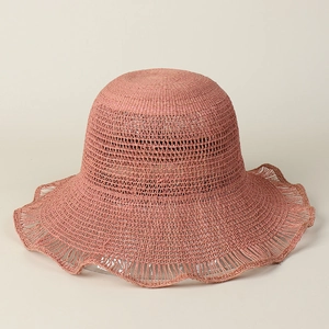 Detail of dusty rose raffia sun hat showing intricate woven texture and wavy brim edges