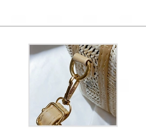 Detail of golden hardware buckle and brown leather strap on woven straw shoulder bag