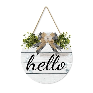 Rustic round wooden Hello sign with faux greenery and burlap bow for farmhouse garden decor