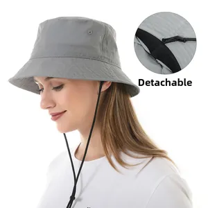 Detail of grey bucket hat featuring a detachable windproof rope and water-resistant fabric