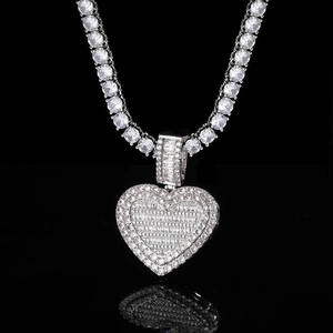 Macro view of silver heart locket pendant with cubic zirconia on tennis chain necklace