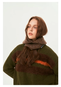 Detailed knit texture of olive green balaclava with orange and brown stripes