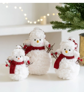 Three plush Christmas snowman figurines with red scarves in varying sizes for festive decor