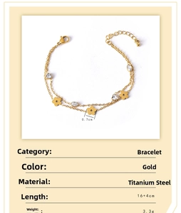 Detail view of double-layer gold titanium bracelet with floral and zircon heart charms