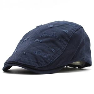 Close-up of navy cotton beret with vintage distressed details and fashion embroidery